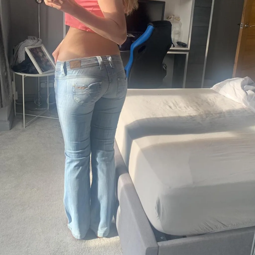 a photo of a sexy teen in low rise tight jeans