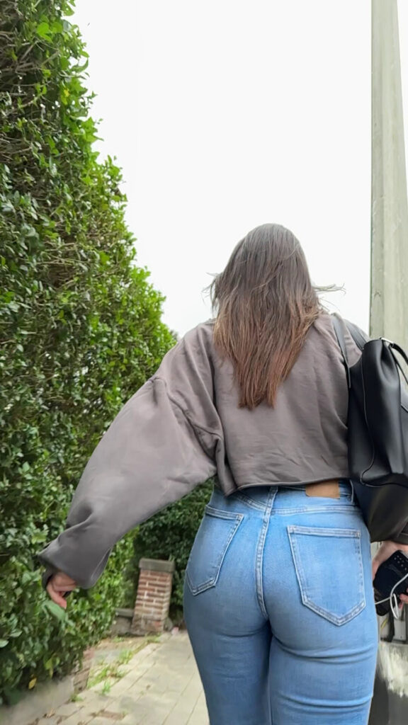 sexy candid girl walking on the street in tight jeans