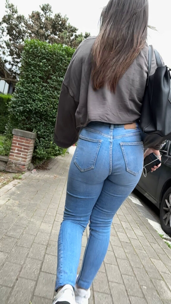 sexy candid girl walking on the street in tight jeans