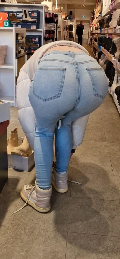 Girl wearing tight light blue jeans and bending over