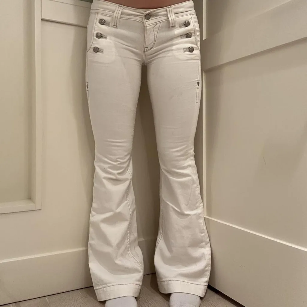 photo of a frontal view if a girl in tight white jeans