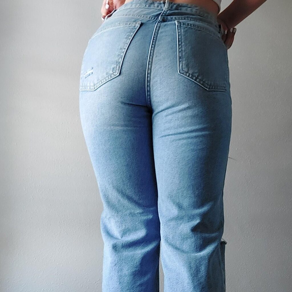 a sexy milf wearing tight jeans, bottom up photo of her ass.