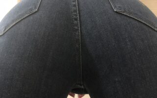 A close up photo of a girls jeans ass bent over