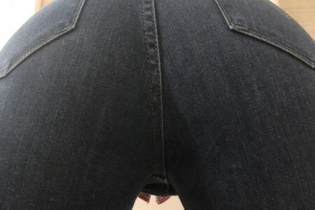 A close up photo of a girls jeans ass bent over