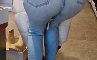 Girl wearing tight light blue jeans and bending over