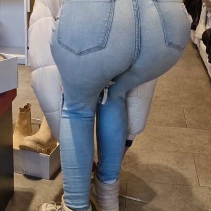 Girl wearing tight light blue jeans and bending over