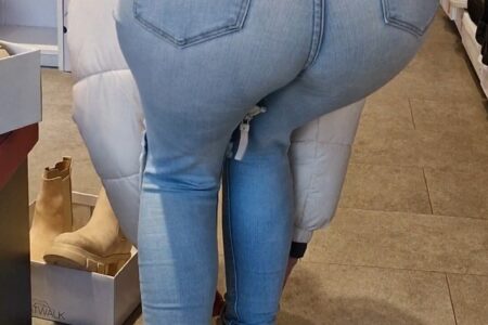 Girl wearing tight light blue jeans and bending over